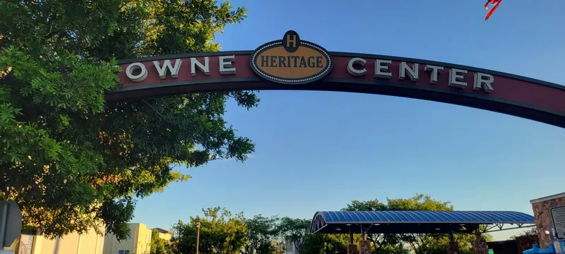 Close-up of the Heritage Towne Center arch and Heritage medallion against a blue sky in Otay Ranch, Chula Vista
