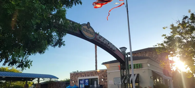 Heritage Towne Center arch seen from the side with the late-afternoon sun behind the shops in Otay Ranch